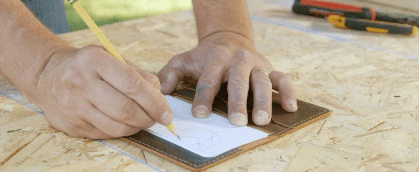 Person drawing shape on paper