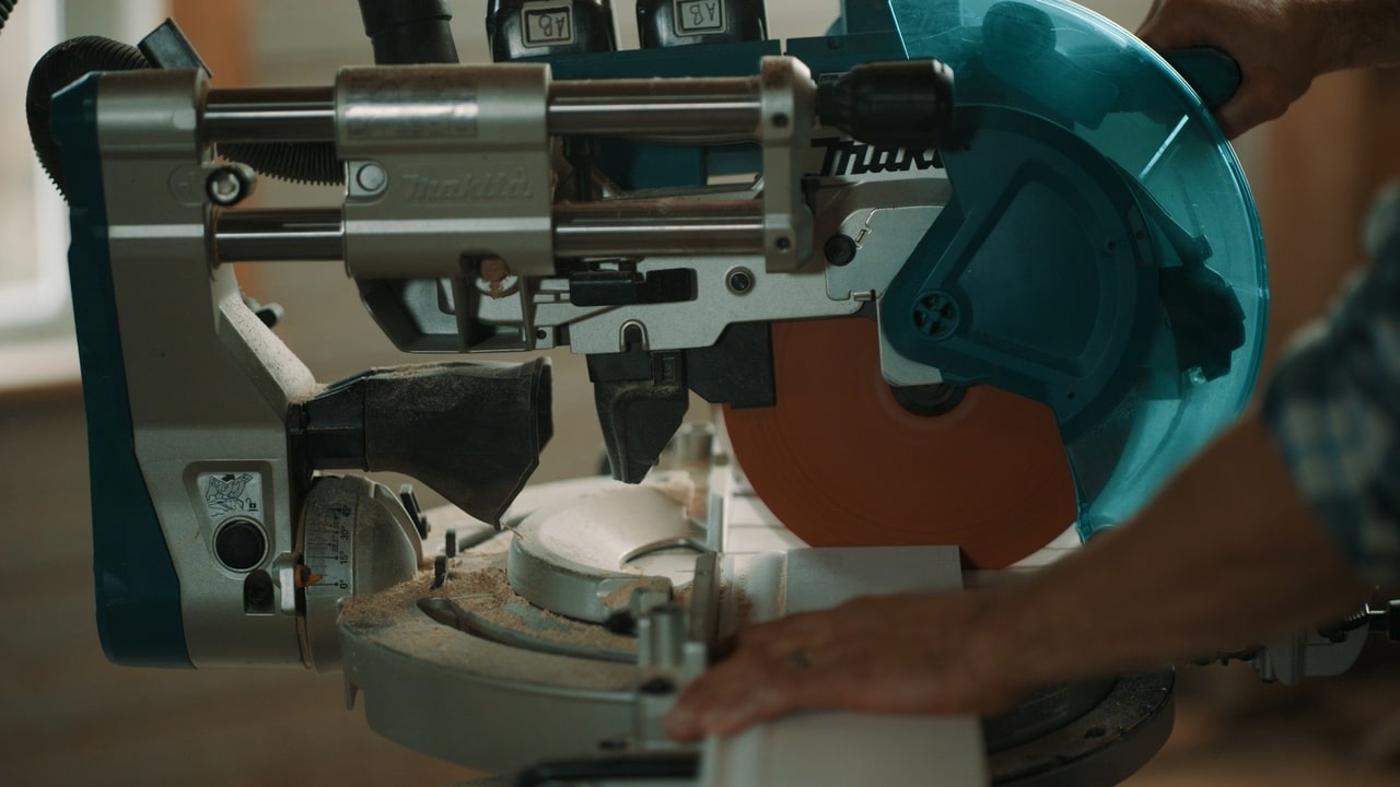 Man using miter saw to make a butt cut