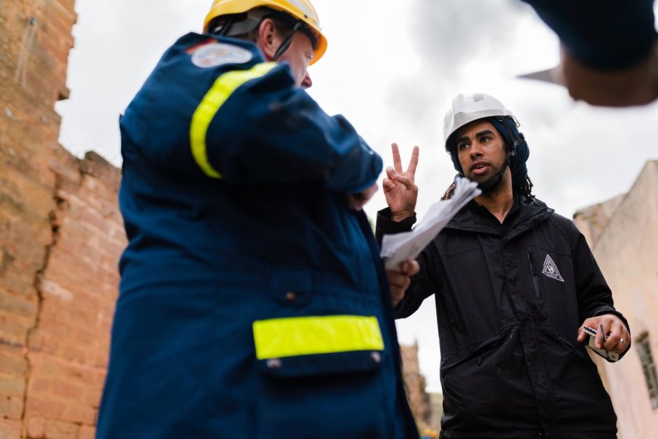 Two construction workers talking on a job site