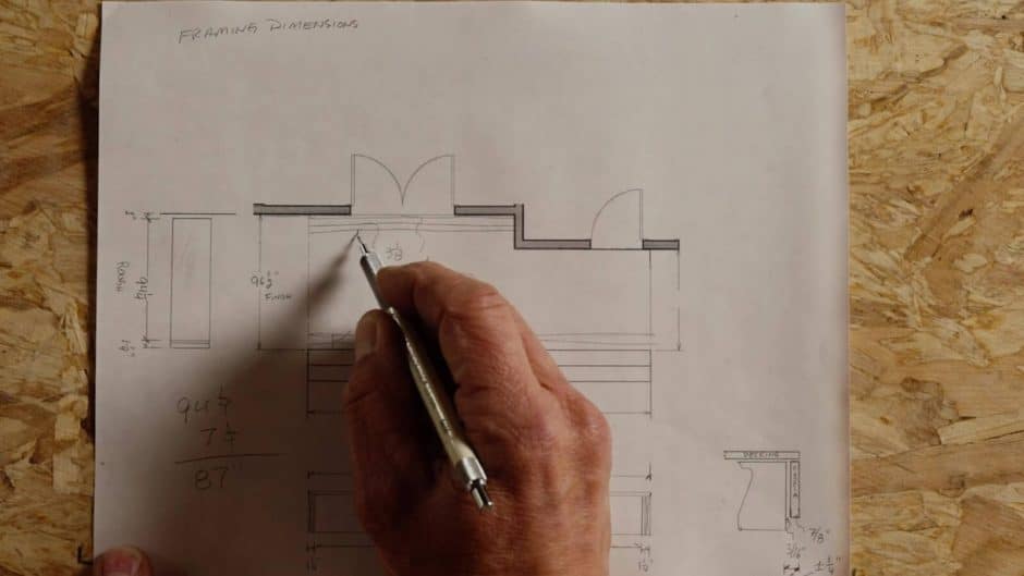 Close-up of a hand drawing on site plans with a pencil