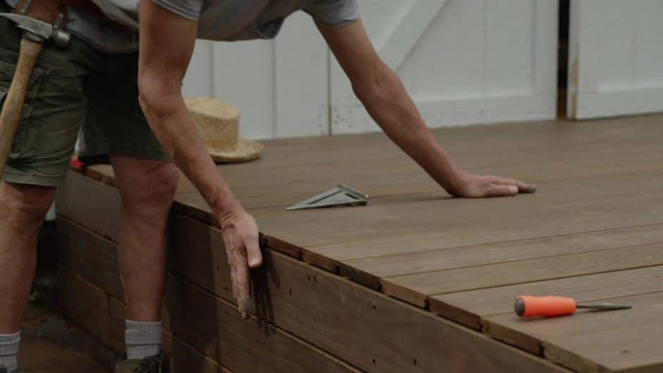 Close-up of worker handling deck boards