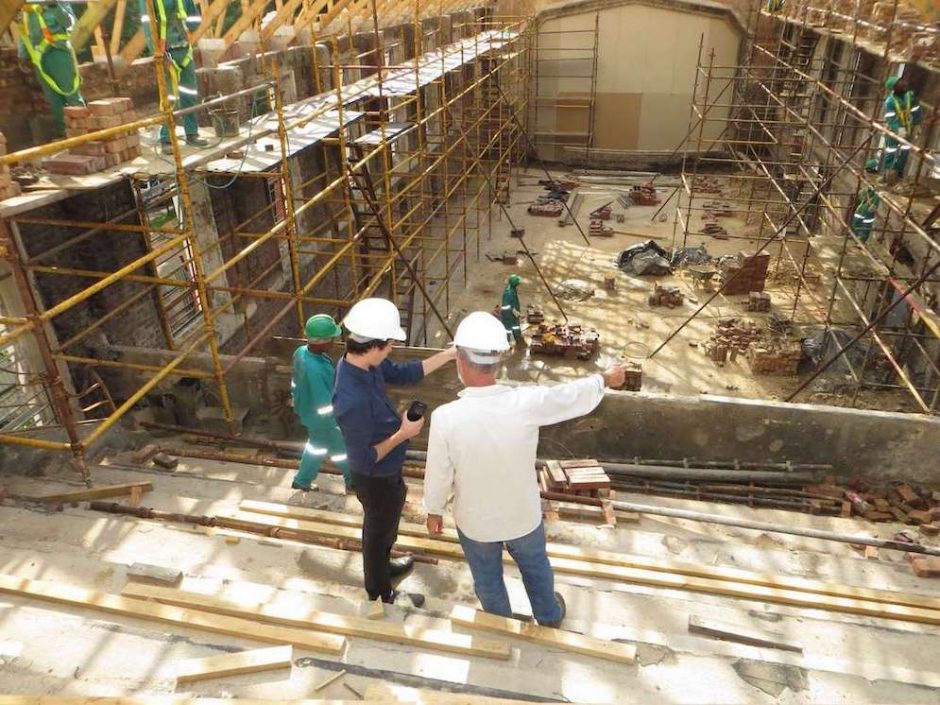 Two construction workers talking and overlooking a jobsite