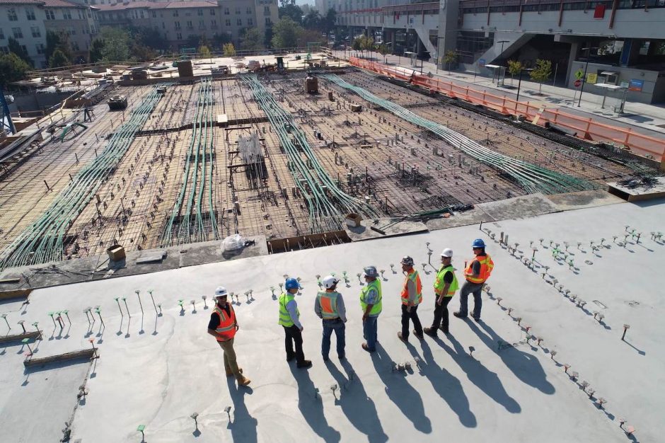 A construction team overlooks a job site