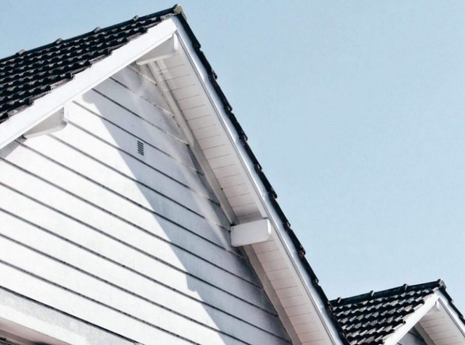 Peak of a house roof with the soffits showing underneath the eaves