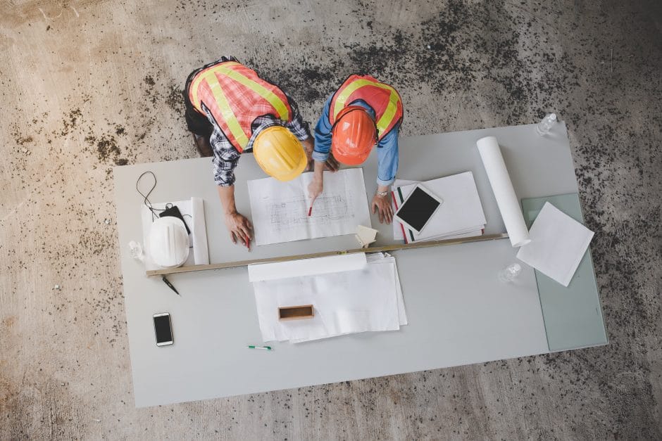 Top view of architects and engineers to help create a blueprint to build a modern building equipped with the skills to fix errors and make suggestions during construction.