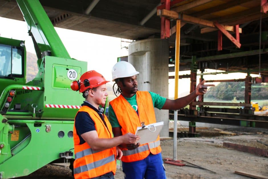 Two construction workers collaborating on a job site