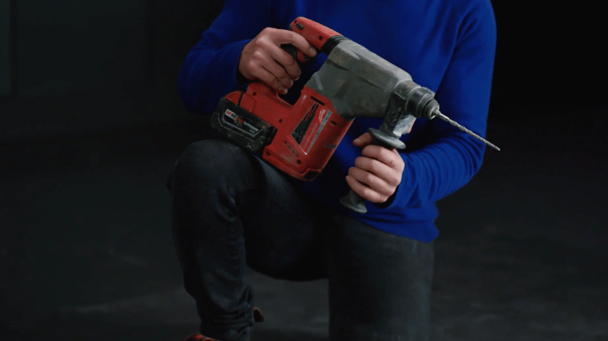 Plumber holds a hammer drill