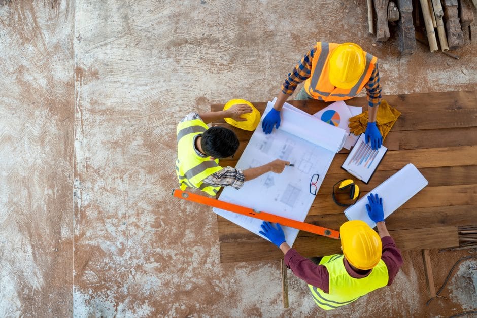 Group of builders having conversation about building plan