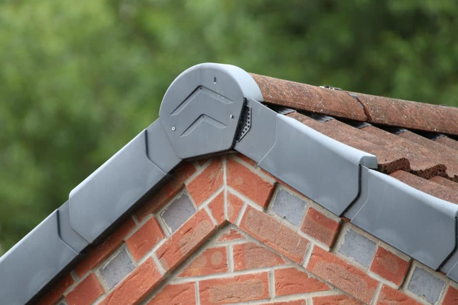 Tiled roof ridgeline and brickwork. Garage roof and flashing.