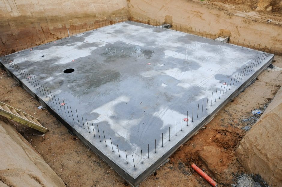 Concrete base in an excavation for a house.