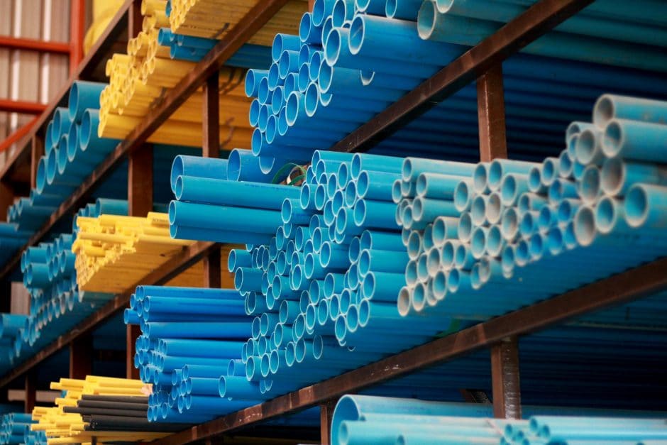 PVC pipes stacked along an industrial shelf