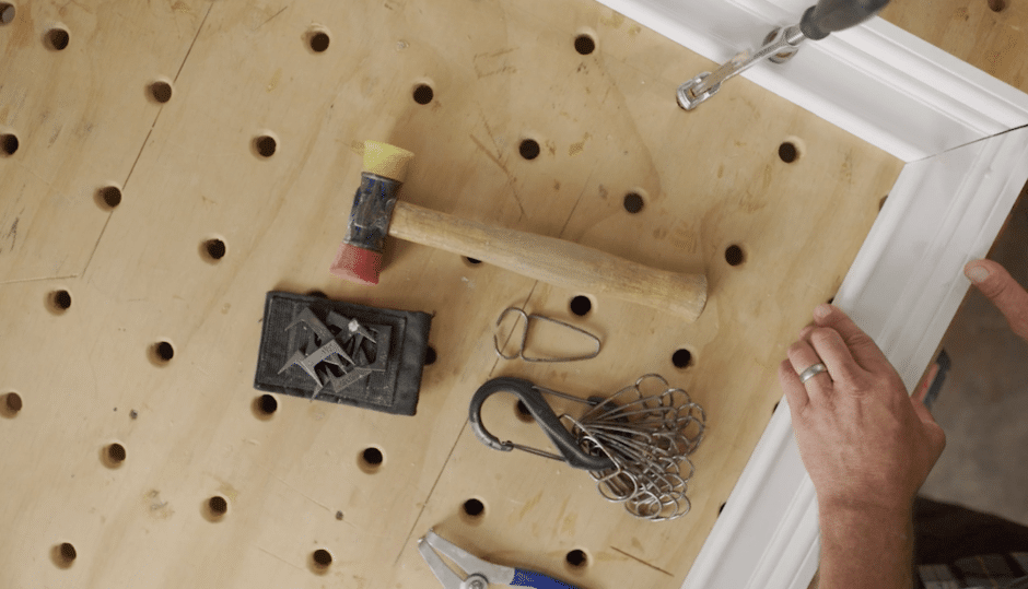 Close-up of trim carpenter pre-assembling a door frame