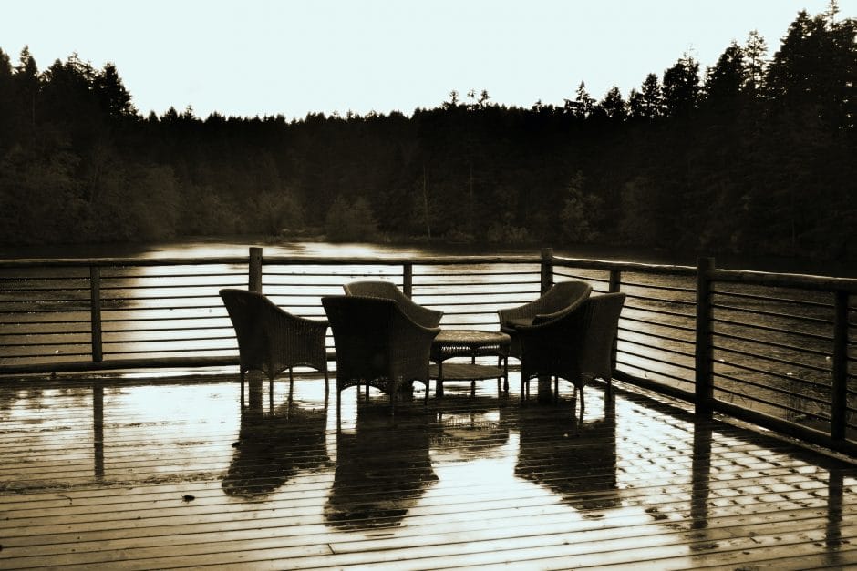 Outdoor deck with chairs overlooking a lake