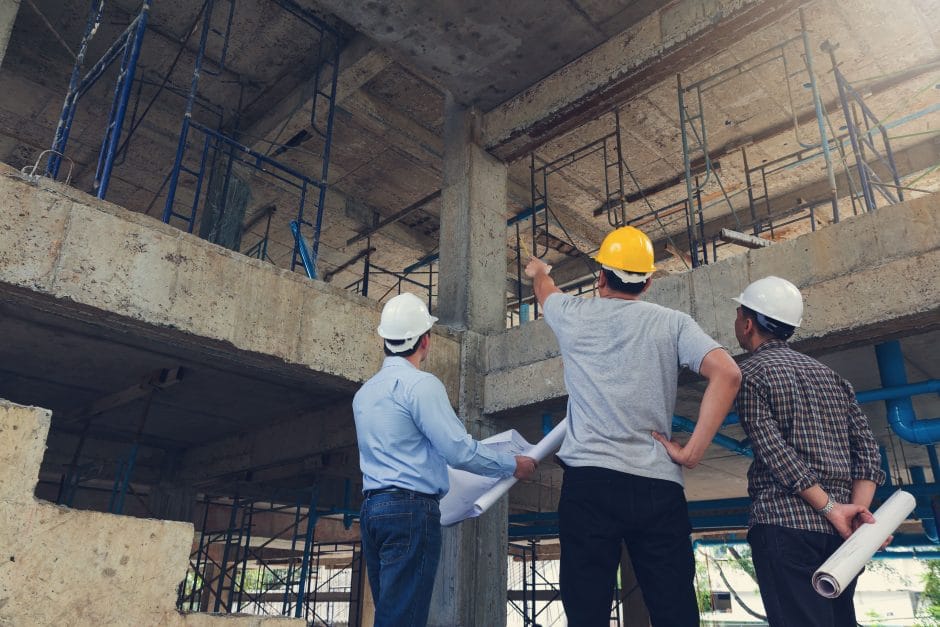 Construction concept of Engineer and Architect working at Construction Site with blue print