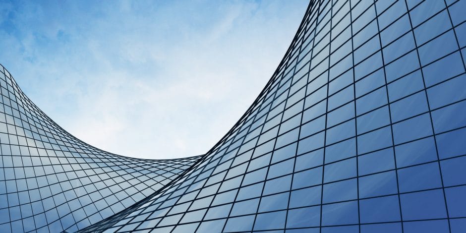 View of the clouds reflected in the curve glass office building