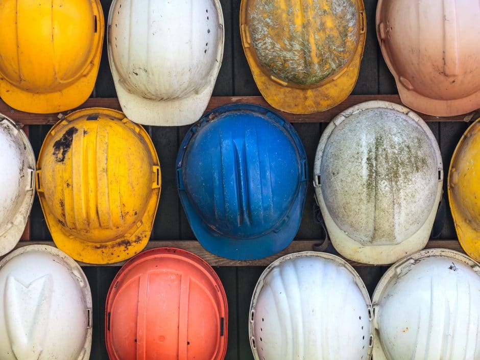 Old and worn colorful construction helmets