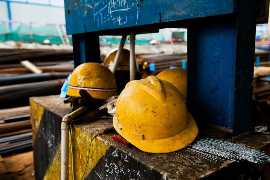 Some construction helmets on work place.