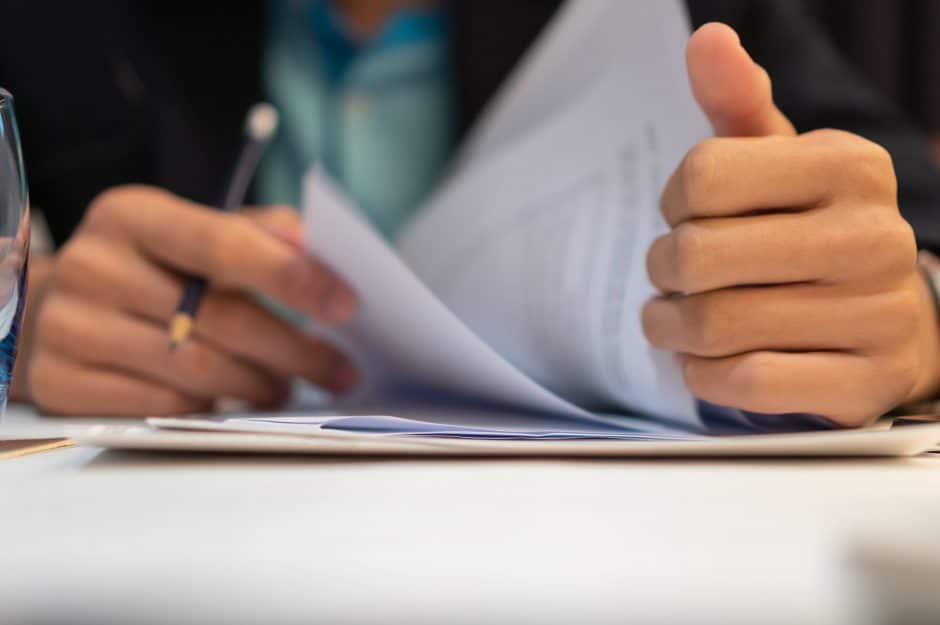 Businessperson reading a contract on a desk