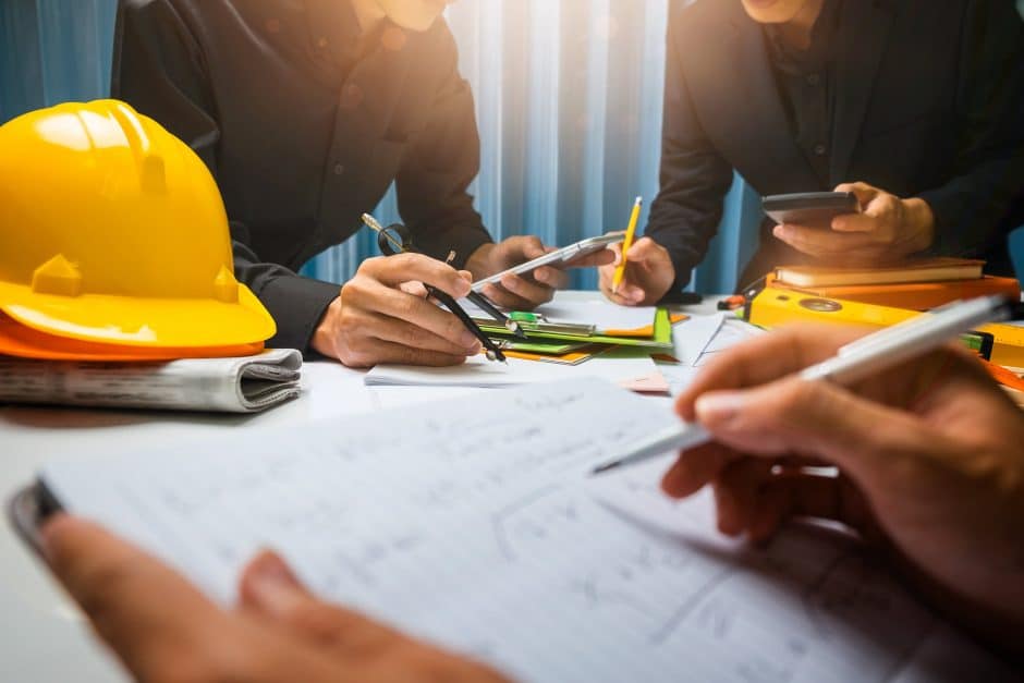 Team of contractors meeting in the office construction site on their architect project.