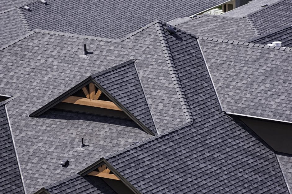 Rooftop in a newly constructed subdivision in Kelowna British Columbia Canada showing asphalt shingles and multiple roof lines